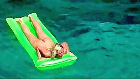Hot blonde milf naked in ocean on public beach