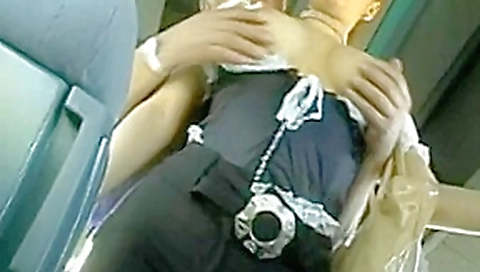 Young girl in sexy waitress outfit by old man on bus