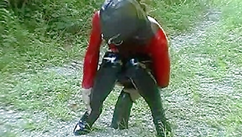 Butt toying in latex during a hike in the nature