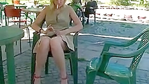Russian blonde poses naked on public terrace