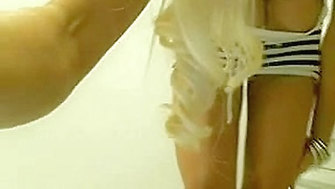 Busty blonde masturbates in public restroom on cam